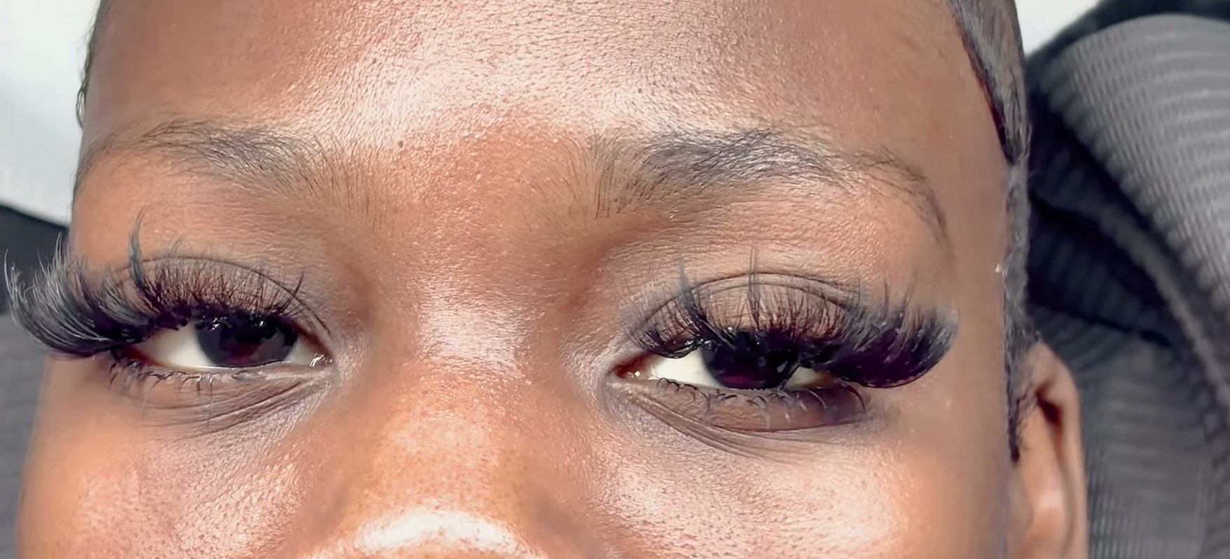 Close-up of a fluffy volume lash set on a client, eyes open